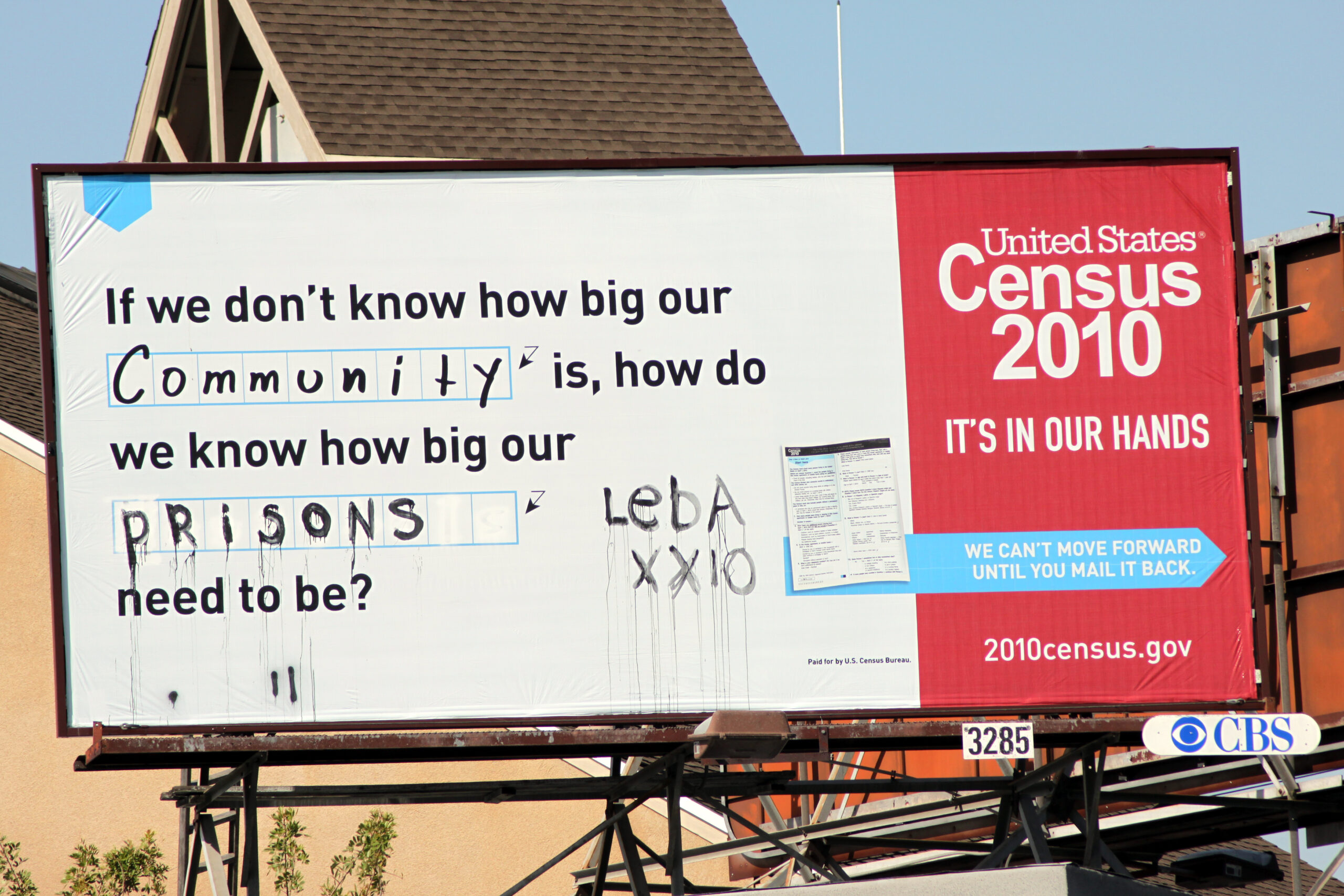 Census BillboardThe billboard originally read If we don't know how big our community is how do we know how big our blank need to be? Someone has spraypainted prisons in the blank
